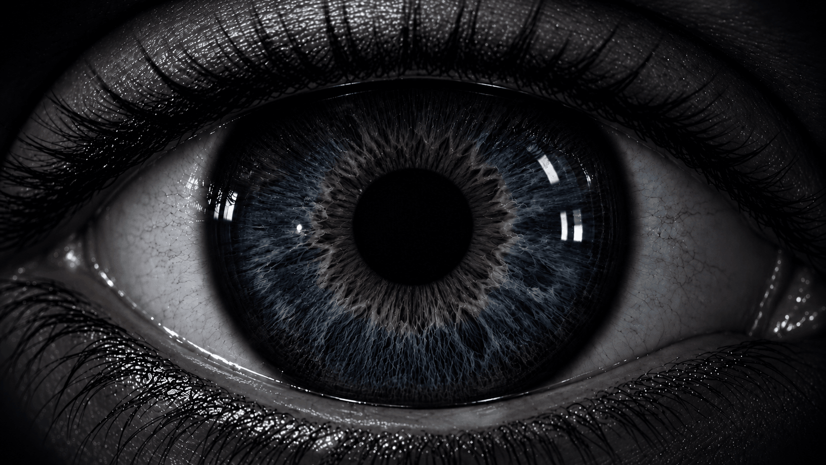 Extreme close-up of a human eye emerging from darkness